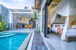 a bedroom with a bed and a swimming pool at Griya Shanti Villas & Spa in Ubud