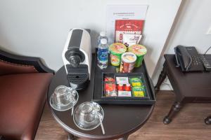 a table with a phone and some drinks on it at 22land Residence Hotel 71 Hang Bong Premium in Hanoi