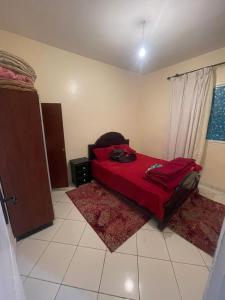 een slaapkamer met een bed met een rode deken bij اقامة طريق الخير in Agadir