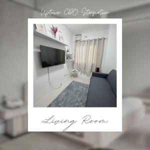 a living room with a tv and a couch at Uptown CDO Staycation in Cagayan de Oro