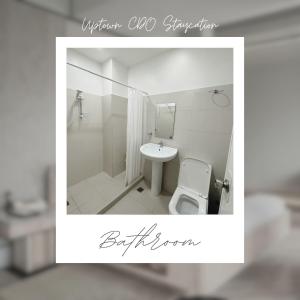 a bathroom with a toilet and a sink at Uptown CDO Staycation in Cagayan de Oro