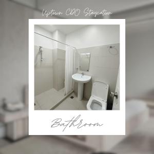 a bathroom with a toilet and a sink at Uptown CDO Staycation in Cagayan de Oro +5 photos
