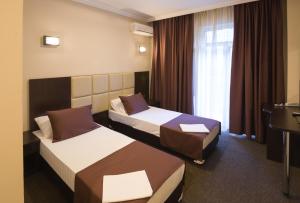 Postel nebo postele na pokoji v ubytování Hotel Marton Business
