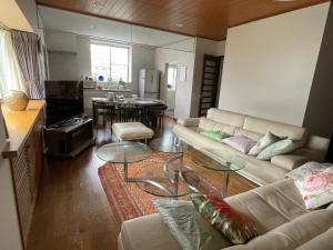 a living room with a couch and a table at 眺めのいい一軒家 in Tokyo