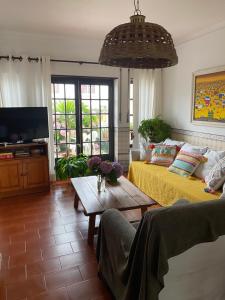 a living room with a couch and a table at Silver Coast Beach House in Torres Vedras