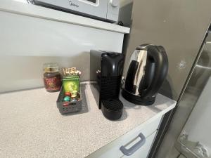 a kitchen with a coffee maker on a counter at NEW My Lodge - AC, Netflix & Wifi in Papeete