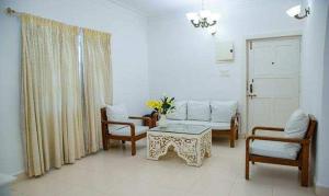 a living room with a couch and chairs and a table at Hotel Toro Highland Beach Resort With Pool - 500M From Candolim Beach in Candolim +30 photos
