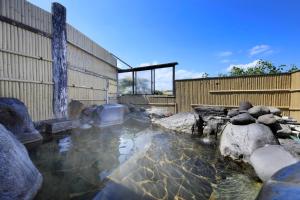 a pool of water in front of a building at Hotel Pony Onsen in Towada