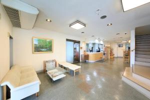 a living room with a couch and a table at Hotel Pony Onsen in Towada