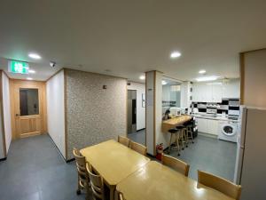 a kitchen and dining room with a table and chairs at Soldongsan Stay in Seogwipo