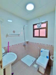 a bathroom with a toilet and a sink at SEA VILLAS Salalah in Salalah