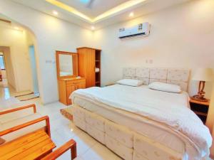 a bedroom with a large bed in a room at SEA VILLAS Salalah in Salalah