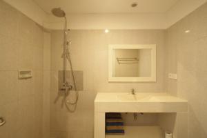 a bathroom with a sink and a shower at Mahamustika Riverside in Canggu