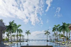 a resort with palm trees and a body of water at The Ritz-Carlton Bali in Nusa Dua