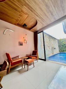 a living room with a table and chairs and a pool at Kebagusan Park Residence in Jakarta