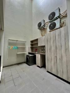 a room with a kitchen with a stove and a microwave at Kebagusan Park Residence in Jakarta