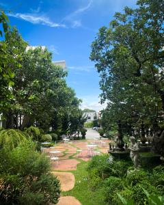 a park with chairs and a fountain and trees at Koranaree Courtyard Boutique Hotel in Nakhon Ratchasima