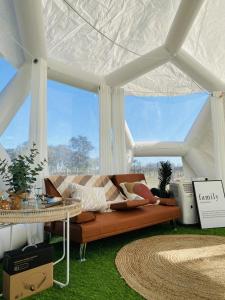 a living room with a couch in a white tent at Coonawarra Hampton Bubble 1 in Glenroy