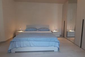 a bedroom with a large bed with two night stands at Casa Maergilù in Pescara