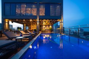 a swimming pool on the roof of a building at Northern Charm Hotel in Ho Chi Minh City