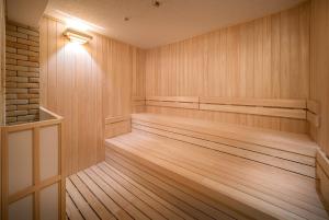 a sauna with wooden floors and a light on the wall at Vessel Hotel Campana Nagoya in Nagoya