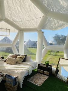 a bedroom with a bed and a view of mountains at Coonawarra Hampton Bubble 2 in Comaum