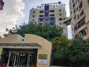 a building with a sign on top of it at Royal Orchid Golden Suites Pune in Pune