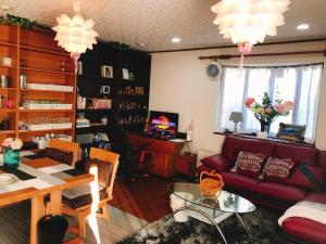 a living room with a couch and a table at Guest House SAKURA - Vacation STAY 57751v in Sakura