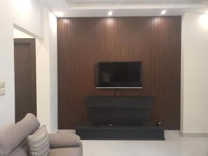 a living room with a flat screen tv on a wall at Perfect view garden in Amman