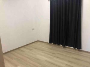 a room with a black curtain and a wooden floor at stevenhome in Quatre Bornes