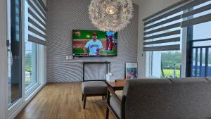 a living room with a tv on a wall at Bibidoongdoong in Jeju