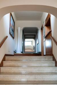 a staircase in a house with a large window at Rex Hotel Residence in Genoa