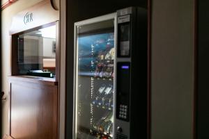 a refrigerator filled with lots of bottles of wine at Rex Hotel Residence in Genoa