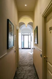 a hallway of a building with a door and a window at Rex Hotel Residence in Genoa