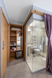 a bathroom with a glass shower and a toilet at Prince Rooftop in Belgrade
