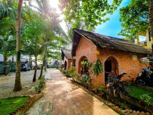 a brick building with a walkway next to a street at AND Resort in Phu Quoc