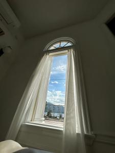 a window with a white curtain in a room at HAKONE DOMA in Hakone