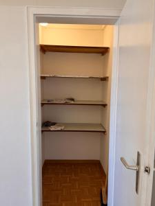 a walk in closet with shelves and a door at Gäste, Handwerker Zimmer - 2 Betten in Rosenfeld