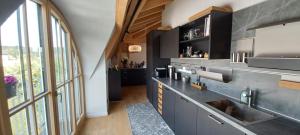 a kitchen with a sink and a large window at Villa Florentina in Bad Wörishofen