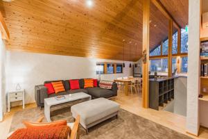 a living room with a couch and a table at Muskoka House — Stunning architect-designed chalet in Hakuba
