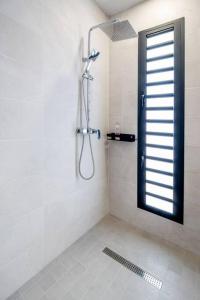a bathroom with a shower with a glass door at Villa standing 52 in Ravine des Cabris