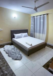 a bedroom with a large bed with a window at Orion Holidays in Mombasa