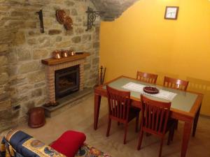 a dining room with a table and a fireplace at Il Baglivo in Agnone