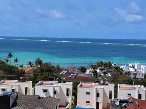 a city with houses and the ocean in the background at Orion Holidays in Mombasa