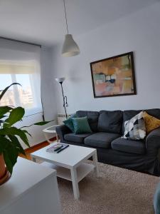 una sala de estar con un sofá y una mesa en En el Parque de las Meanas., en Avilés