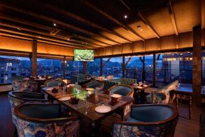 a restaurant with tables and chairs with a view at Kantipur Village in Kathmandu