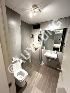 a bathroom with a toilet and a sink at Geo Bukit Rimau Apartment in Shah Alam