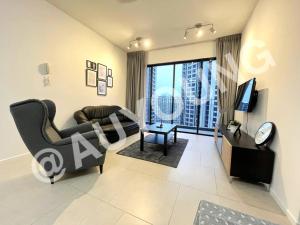 a living room with a couch and a tv at Geo Bukit Rimau Apartment in Shah Alam