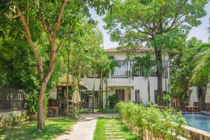 a house with a pool in front of it at Saline Residence in Siem Reap