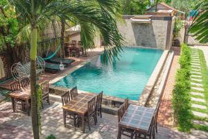 an overhead view of a swimming pool with tables and chairs at Saline Residence in Siem Reap